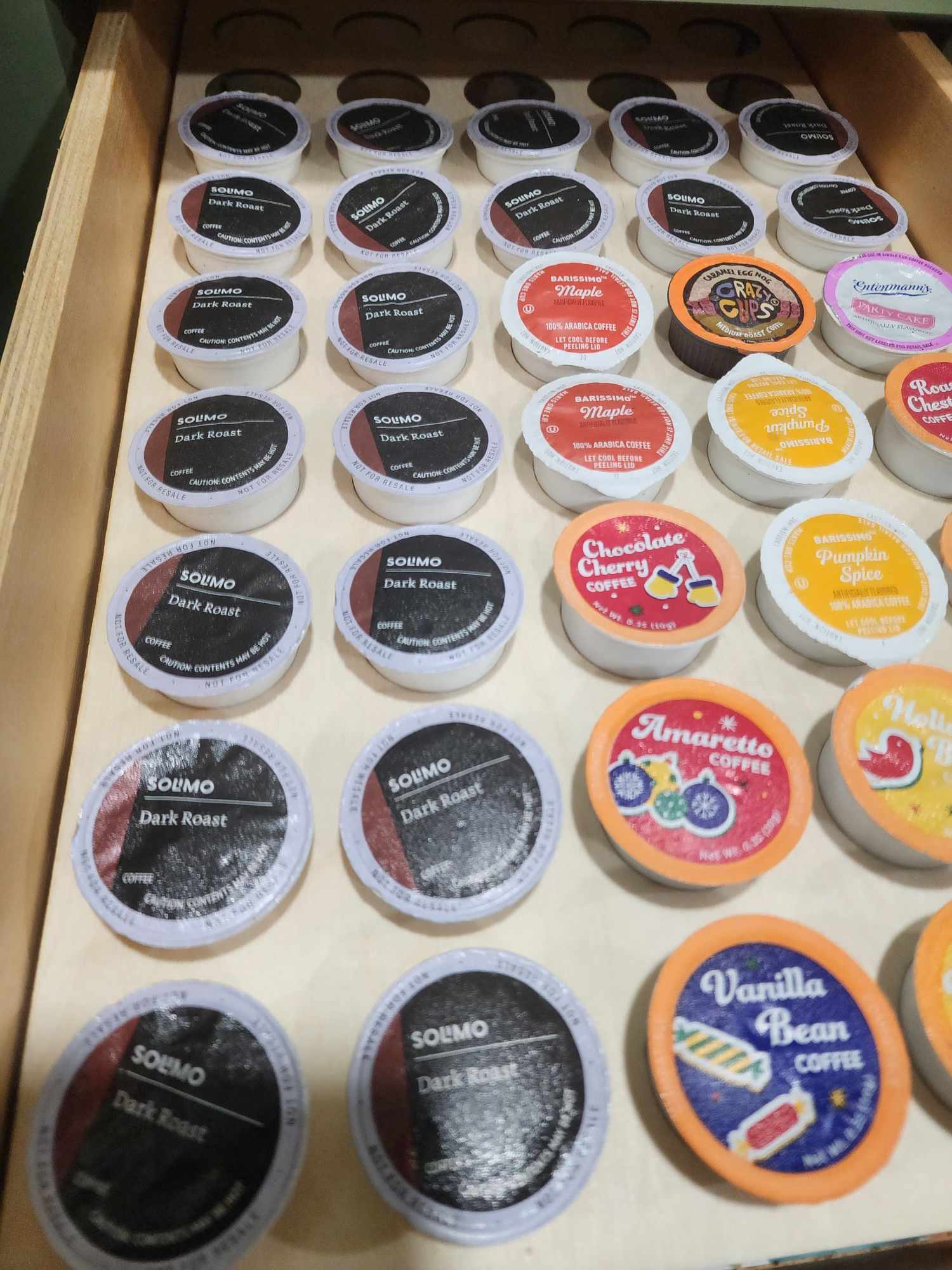 Shows a coffee k cup drawer organizer full of coffee pods